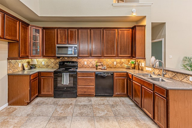 2268 Fletcher Trl, Plano, TX 75025 - kitchen with black appliances, decorative backsplash, a peninsula, and glass insert cabinets