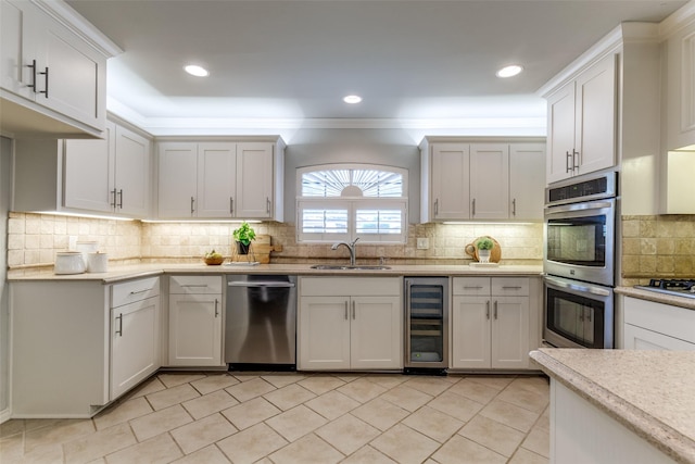 6404 Camille Ave, Dallas, TX 75252 - kitchen featuring wine cooler, appliances with stainless steel finishes, decorative backsplash, light countertops, and white cabinets