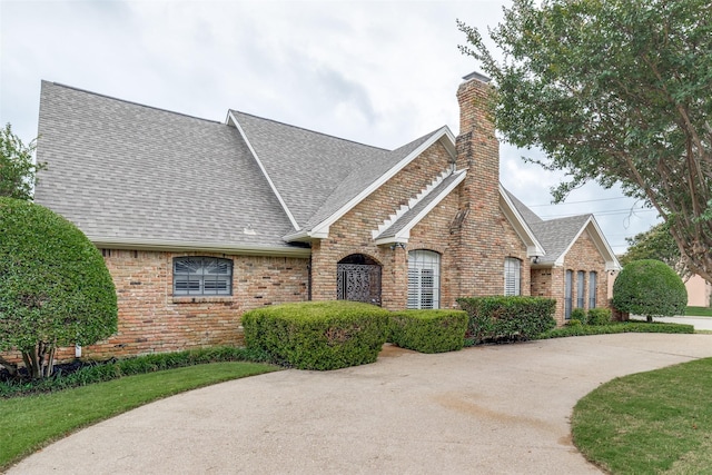 6404 Camille Ave, Dallas, TX 75252 - view of front of home with a shingled roof, a chimney, and brick siding