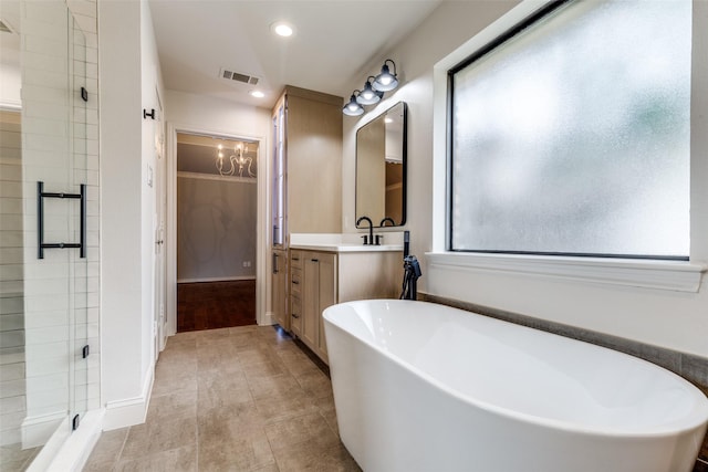 6404 Camille Ave, Dallas, TX 75252 - bathroom with vanity, a freestanding tub, a shower stall, recessed lighting, and a chandelier