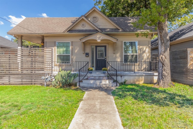825 W 12th St, Dallas, TX 75208 - bungalow-style home with a front yard and roof with shingles