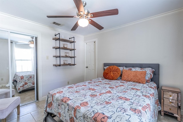 825 W 12th St, Dallas, TX 75208 - bedroom featuring ceiling fan, crown molding, light tile patterned flooring, and a closet