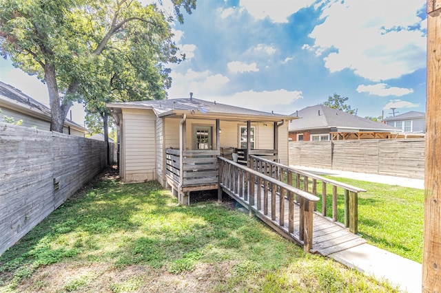 825 W 12th St, Dallas, TX 75208 - rear view of house featuring a fenced backyard and a wooden deck
