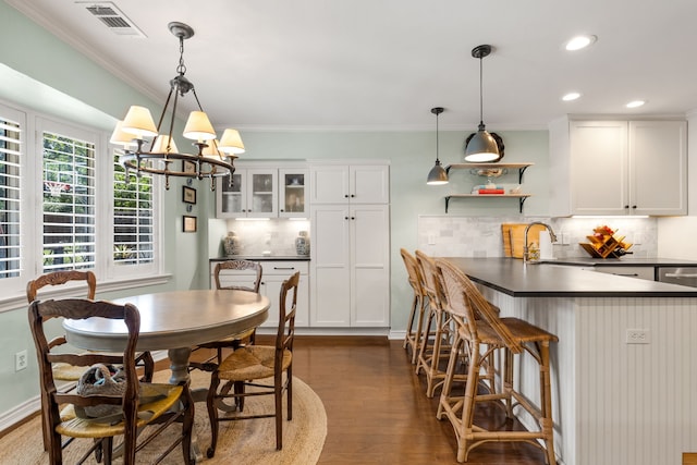 7120 Leameadow Dr, Dallas, TX 75248 - dining space with dark wood-type flooring, a chandelier, crown molding, and recessed lighting