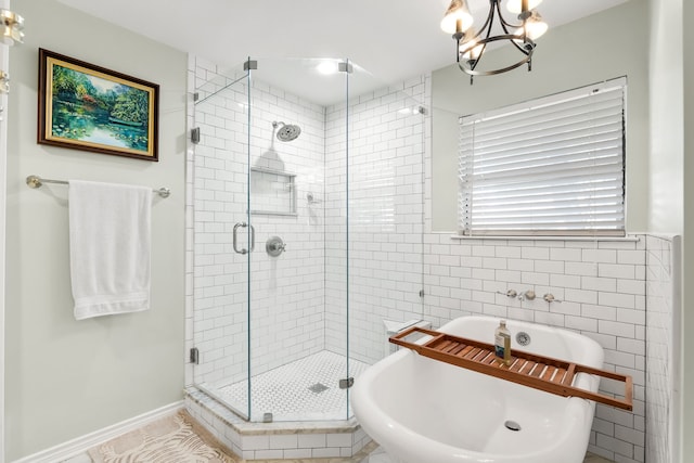 7120 Leameadow Dr, Dallas, TX 75248 - bathroom featuring a freestanding tub, a stall shower, a chandelier, and tile walls