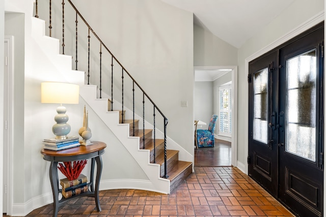 7120 Leameadow Dr, Dallas, TX 75248 - foyer entrance featuring vaulted ceiling, stairway, brick floors, and french doors