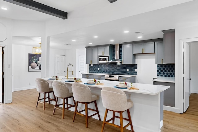 2258 Valley, Carrollton, TX 75006 - kitchen featuring wall chimney exhaust hood, stainless steel microwave, recessed lighting, tasteful backsplash, and a kitchen breakfast bar