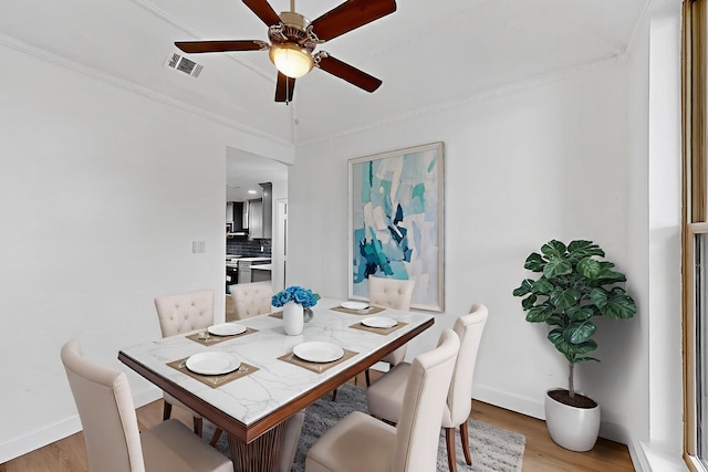 2258 Valley, Carrollton, TX 75006 - dining area with light wood finished floors, ceiling fan, and crown molding