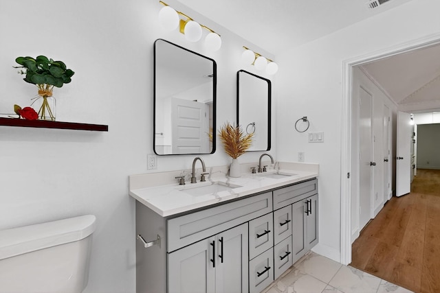 2258 Valley, Carrollton, TX 75006 - bathroom featuring double vanity and marble look tile flooring