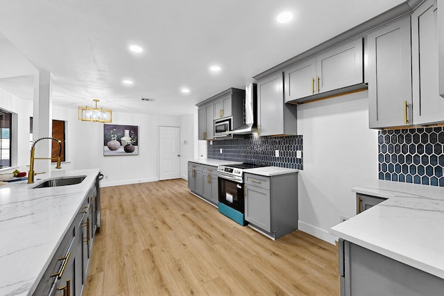 2258 Valley, Carrollton, TX 75006 - kitchen featuring appliances with stainless steel finishes, gray cabinets, a chandelier, recessed lighting, and light wood finished floors