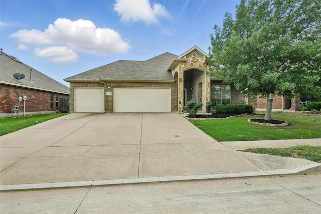 14049 Wrangler Way, Haslet, TX 76052 - view of front of house featuring brick siding, concrete driveway, an attached garage, a shingled roof, and a front yard