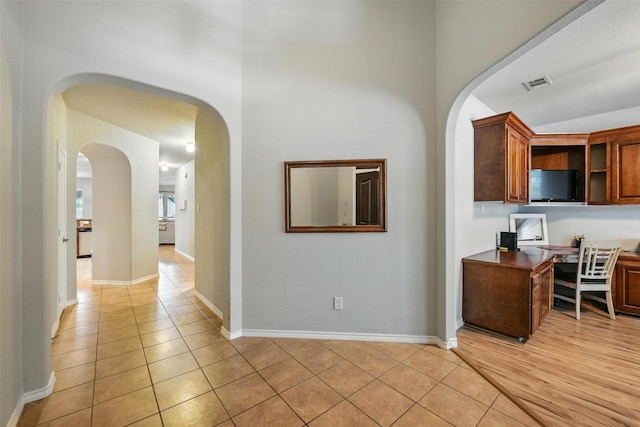 14049 Wrangler Way, Haslet, TX 76052 - corridor with arched walkways, light tile patterned floors, and a desk