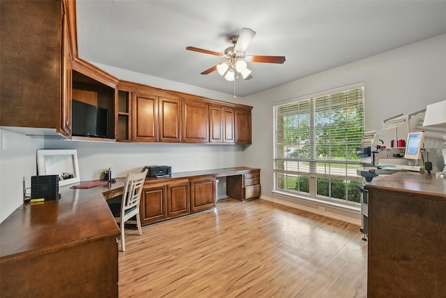 14049 Wrangler Way, Haslet, TX 76052 - home office with built in desk, a ceiling fan, and light wood-type flooring