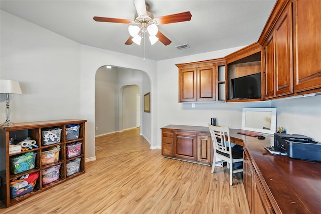 14049 Wrangler Way, Haslet, TX 76052 - home office with a ceiling fan, arched walkways, light wood-style flooring, and built in study area