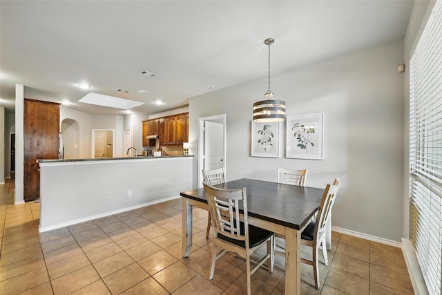 14049 Wrangler Way, Haslet, TX 76052 - dining space with light tile patterned flooring, arched walkways, and recessed lighting