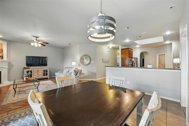 14049 Wrangler Way, Haslet, TX 76052 - dining area featuring arched walkways, a fireplace, a ceiling fan, recessed lighting, and a chandelier