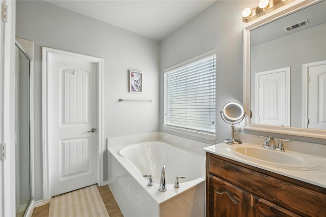 14049 Wrangler Way, Haslet, TX 76052 - bathroom with vanity, a bath, a shower stall, and tile patterned flooring
