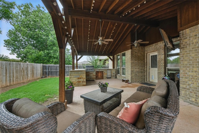 14049 Wrangler Way, Haslet, TX 76052 - fenced backyard featuring an outdoor kitchen, a ceiling fan, a patio, and an outdoor hangout area