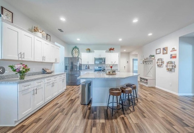 421 Atmore St, Azle, TX 76020 - kitchen featuring stainless steel appliances, light wood finished floors, white cabinetry, and recessed lighting