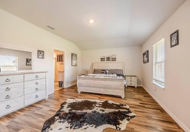 421 Atmore St, Azle, TX 76020 - bedroom with light wood-style floors, lofted ceiling, and connected bathroom