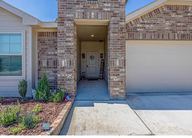 421 Atmore St, Azle, TX 76020 - entrance to property featuring brick siding, an attached garage, and driveway