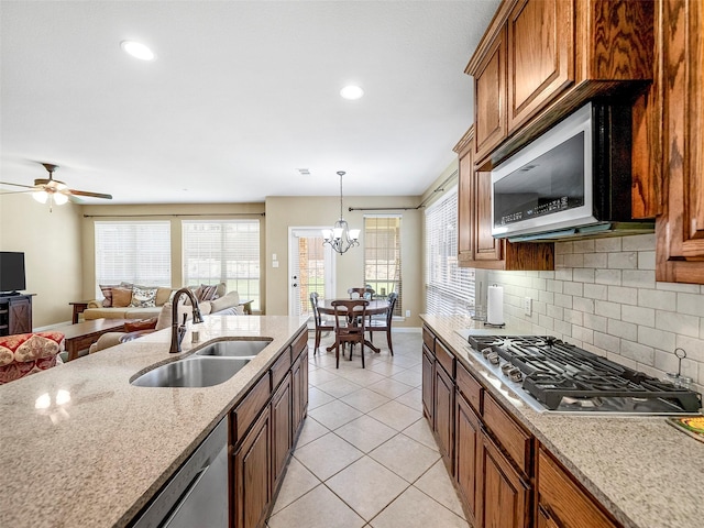 7804 Rocky Mountain Ln, Mckinney, TX 75070 - kitchen featuring appliances with stainless steel finishes, backsplash, healthy amount of natural light, light tile patterned flooring, and recessed lighting