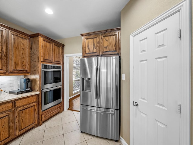7804 Rocky Mountain Ln, Mckinney, TX 75070 - kitchen with stainless steel appliances, tasteful backsplash, and brown cabinetry