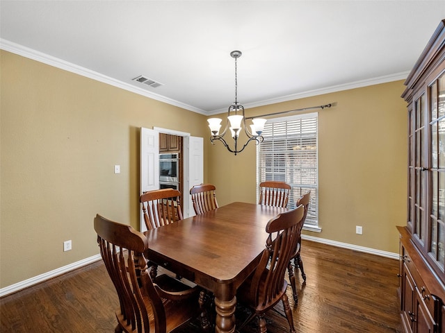7804 Rocky Mountain Ln, Mckinney, TX 75070 - dining area featuring a chandelier, dark wood-style flooring, and crown molding
