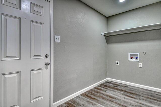 1112 Leyenda Dr, Mesquite, TX 75149 - laundry area featuring wood finished floors, washer hookup, electric dryer hookup, hookup for a gas dryer, and a textured wall