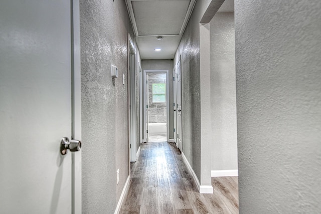 1112 Leyenda Dr, Mesquite, TX 75149 - corridor with a textured wall, wood finished floors, and attic access