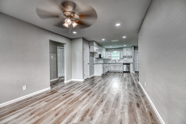 1112 Leyenda Dr, Mesquite, TX 75149 - unfurnished living room with ceiling fan, light wood-style floors, a textured wall, and recessed lighting