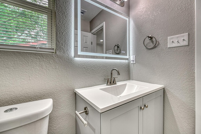 1112 Leyenda Dr, Mesquite, TX 75149 - half bathroom with vanity and a textured wall
