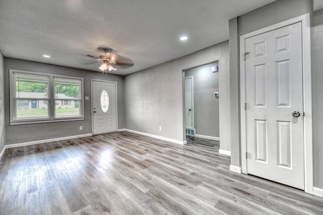 1112 Leyenda Dr, Mesquite, TX 75149 - foyer entrance featuring a textured wall, ceiling fan, wood finished floors, a textured ceiling, and recessed lighting