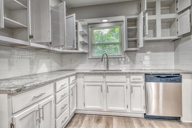 1112 Leyenda Dr, Mesquite, TX 75149 - kitchen with open shelves, stainless steel dishwasher, white cabinets, decorative backsplash, and light stone counters