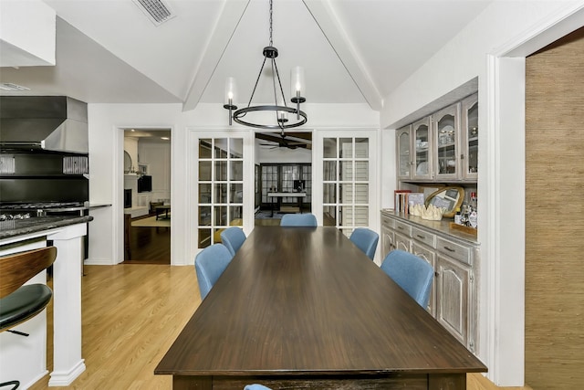 2425 Northgate Dr W, Irving, TX 75062 - dining area with ceiling fan, a chandelier, and light wood-type flooring