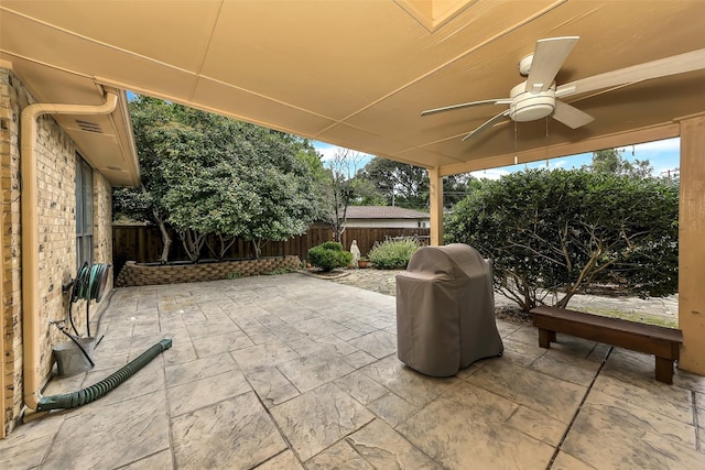 2425 Northgate Dr W, Irving, TX 75062 - fenced backyard with ceiling fan, a grill, and a patio area