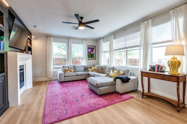 1404 Settlers Ct, Allen, TX 75002 - living room with ceiling fan, light wood-type flooring, and a fireplace