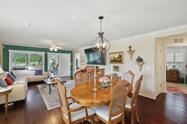 7972 Tatum Dr, Frisco, TX 75036 - dining area featuring crown molding, dark wood finished floors, ceiling fan, and a chandelier