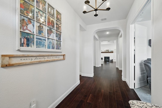 1208 S Pecan Pkwy, Northlake, TX 76247 - corridor with arched walkways, a chandelier, and wood-type flooring