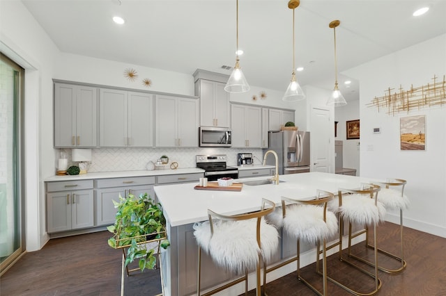 1078 Maverick Dr, Allen, TX 75013 - kitchen with appliances with stainless steel finishes, gray cabinets, decorative backsplash, dark wood-style flooring, and recessed lighting