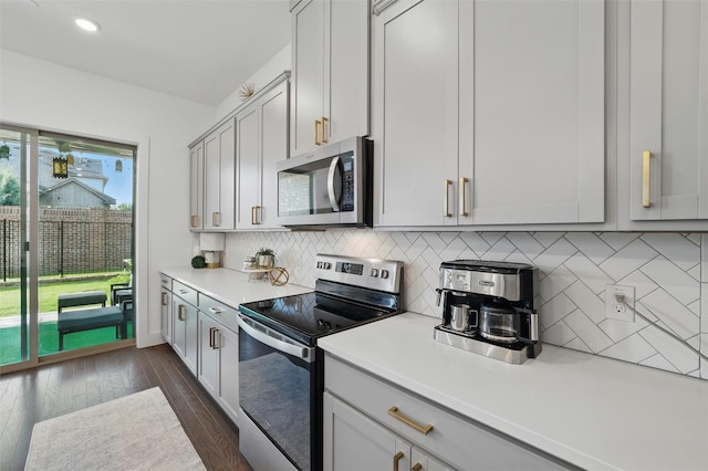 1078 Maverick Dr, Allen, TX 75013 - kitchen with appliances with stainless steel finishes, light countertops, dark wood-style flooring, backsplash, and recessed lighting