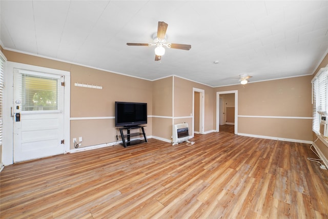 701 S Austin St, De Leon, TX 76444 - unfurnished living room with ceiling fan, heating unit, light wood-type flooring, and crown molding