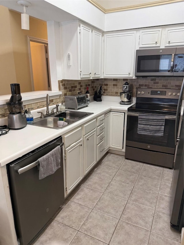 6732 Driffield Cir E, North Richland Hills, TX 76182 - kitchen with stainless steel appliances, decorative backsplash, light countertops, and light tile patterned floors