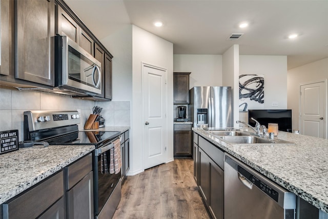 706 Meadow Creek Ln, Josephine, TX 75189 - kitchen featuring appliances with stainless steel finishes, wood finished floors, backsplash, dark brown cabinetry, and recessed lighting