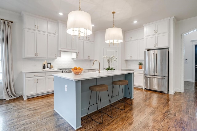 6013 El Campo Ave, Fort Worth, TX 76107 - kitchen with high end fridge, light countertops, recessed lighting, white cabinets, and backsplash