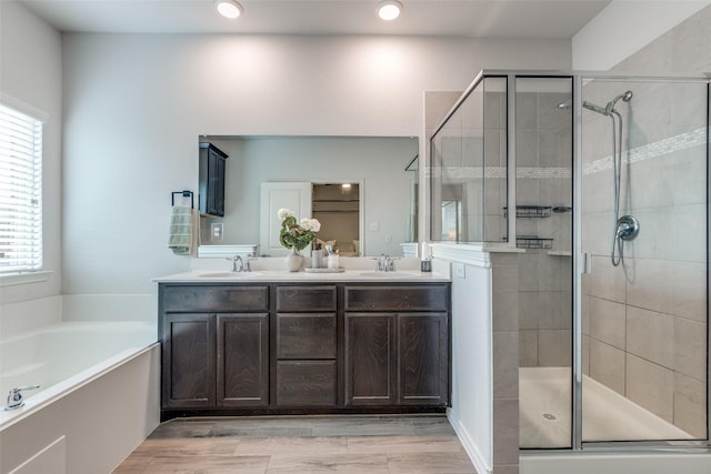 604 Grand Falls Ln, Mckinney, TX 75071 - full bathroom with a shower stall, double vanity, a garden tub, wood finished floors, and recessed lighting