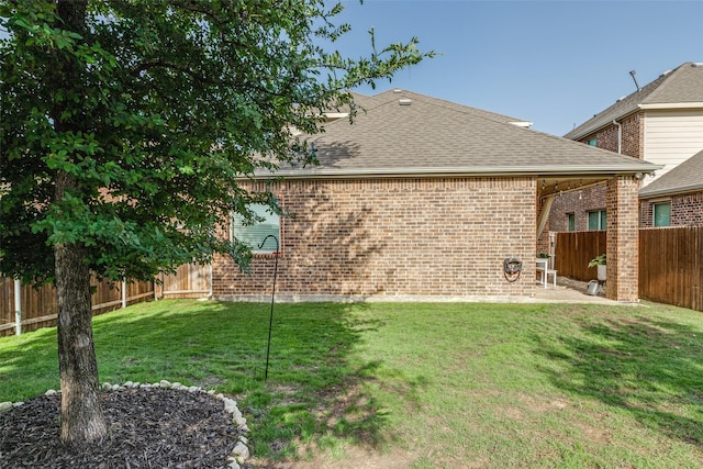 604 Grand Falls Ln, Mckinney, TX 75071 - back of house featuring a fenced backyard, brick siding, and a shingled roof