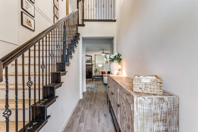 604 Grand Falls Ln, Mckinney, TX 75071 - staircase with wood finished floors, ceiling fan, and a high ceiling