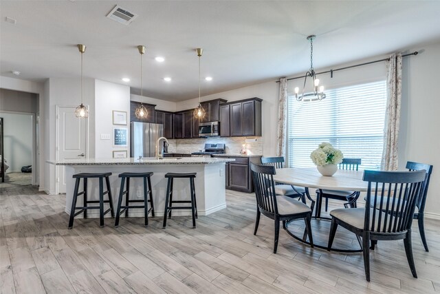 604 Grand Falls Ln, Mckinney, TX 75071 - dining area with light wood-style flooring, a chandelier, and recessed lighting