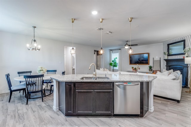 604 Grand Falls Ln, Mckinney, TX 75071 - kitchen with dishwasher, open floor plan, a fireplace, light stone counters, and dark brown cabinetry